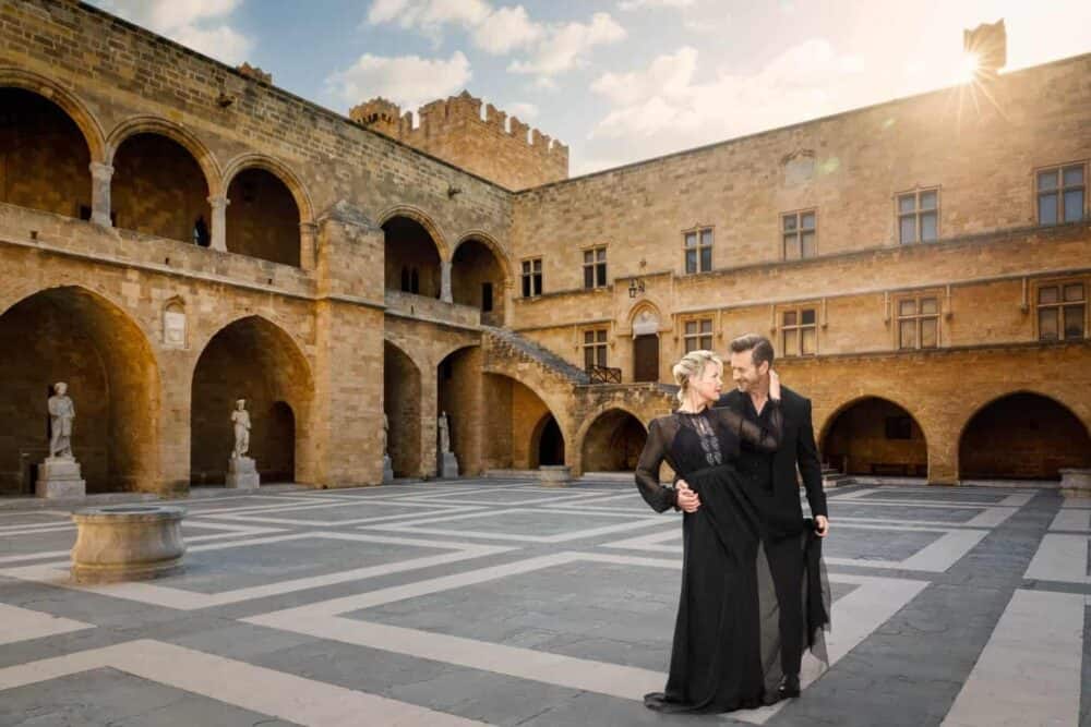 Affluent-couple-in-evening-wear-dancing-in-palace-courtyard